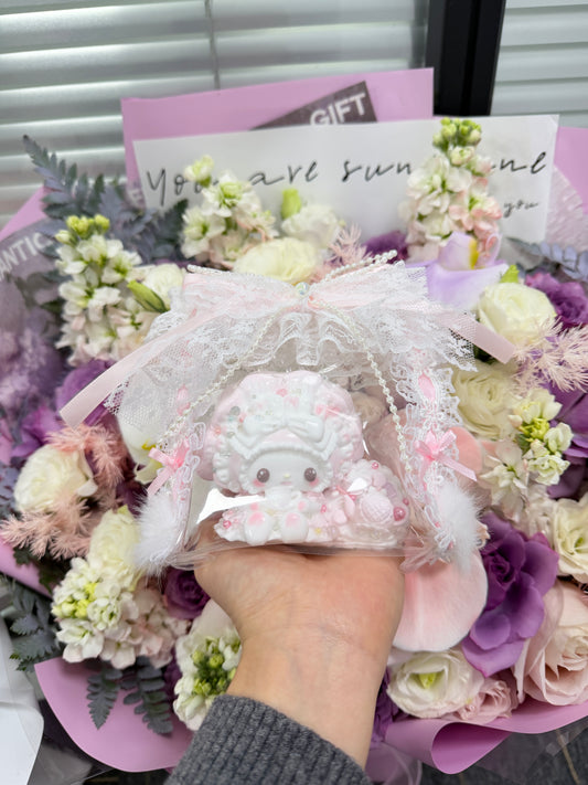 Pink and white kawaii cream bunny squeeze toy with whipped cream swirl texture and colourful bead decorations, packaged in a lace and ribbon gift bag