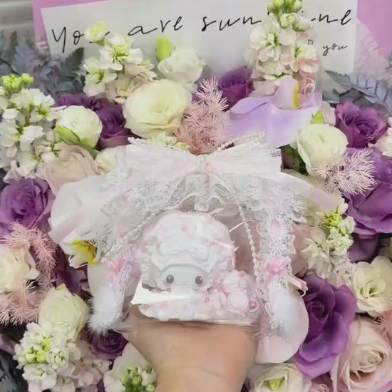 Hand holding a soft food-grade silicone cream bunny squishy toy showing its palm-sized scale and detailed cream swirl surface